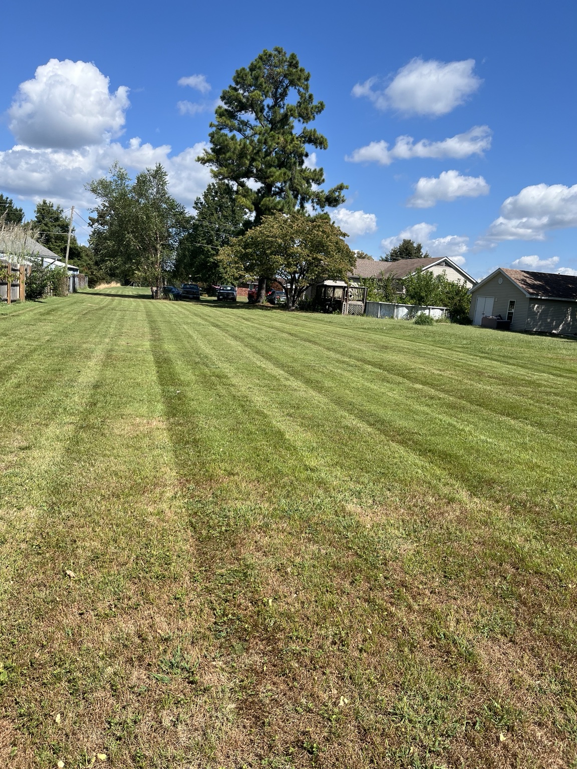 McGee's Landscaping lawn mowing project with clean striping